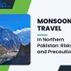 Monsoon travel in northern Pakistan, rescue workers help stranded tourists after a landslide on a mountain road